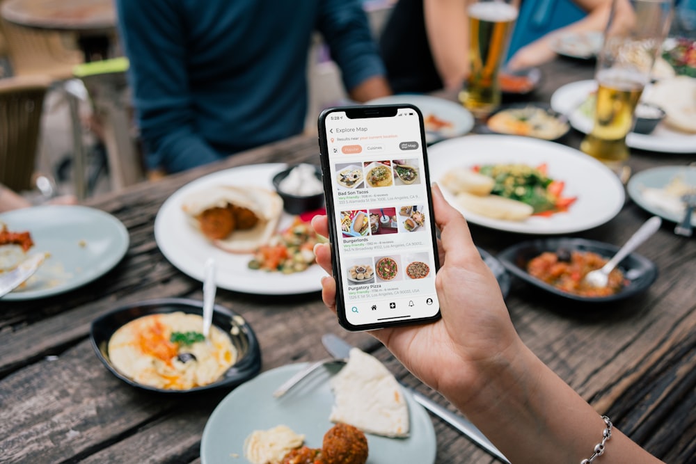 Toast Website Development for Restaurants 25 person holding white and black labeled card