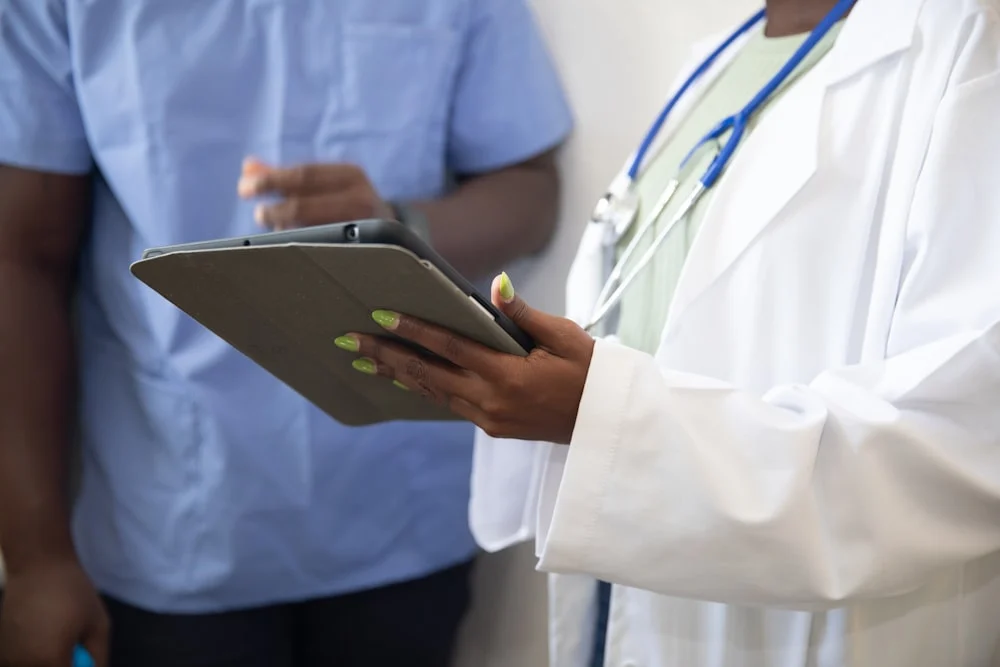 clinical trial email marketing a doctor showing a patient something on the tablet