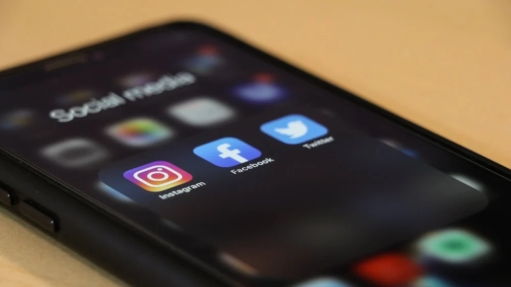 Phone on a table showing a social media profile grid