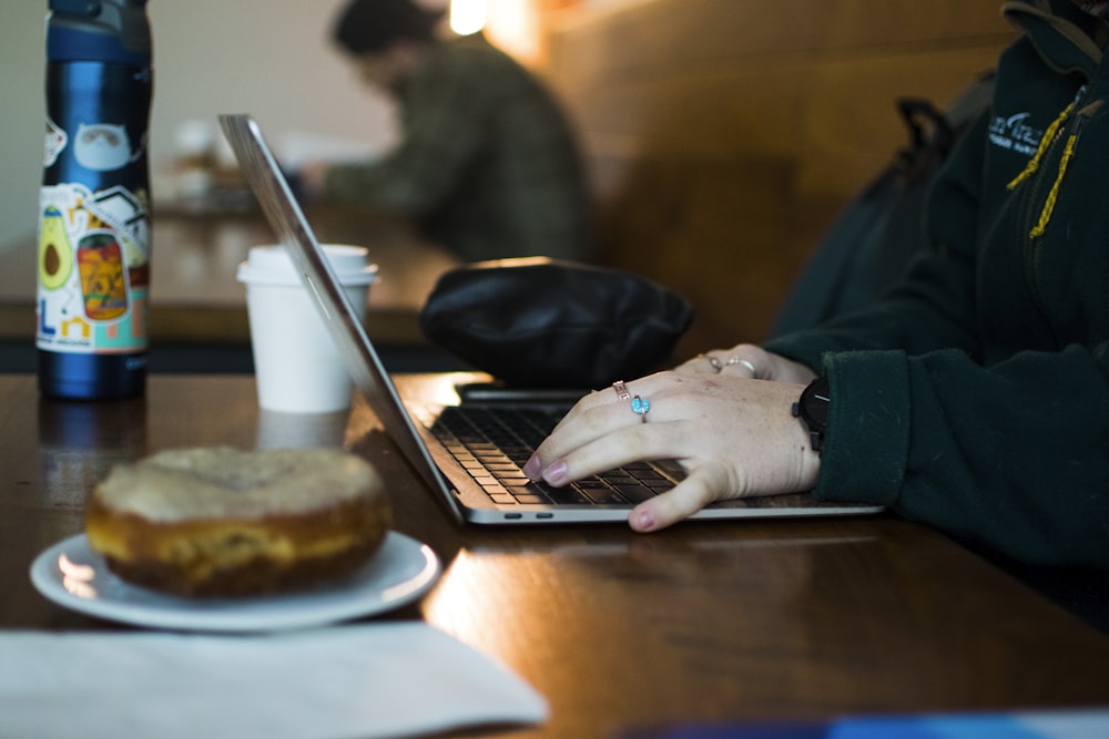Toast POS Equipment and Hardware for Restaurants 27 a person using a laptop on a wooden table