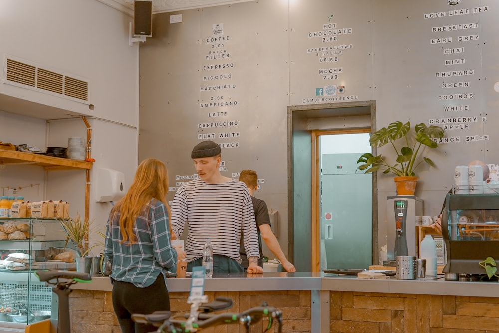 SpotOn API and Custom Integrations for Restaurants 27 man and woman talking in front of gray tabletop inside shop