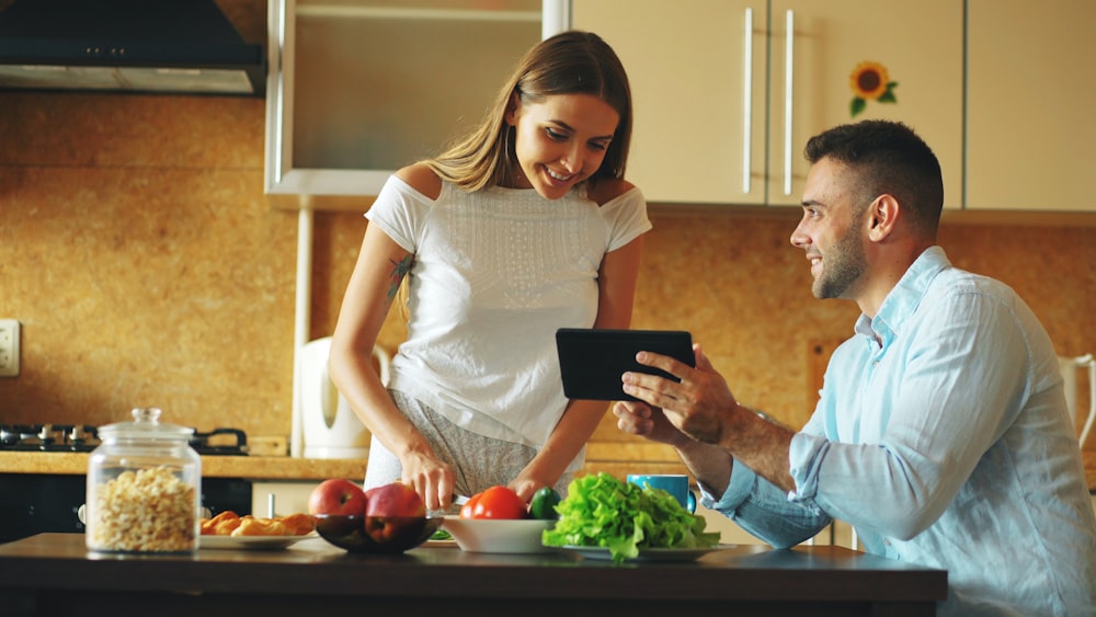 Aloha API and Custom Integrations for Restaurants 25 Couple looking at tablet while cooking in kitchen
