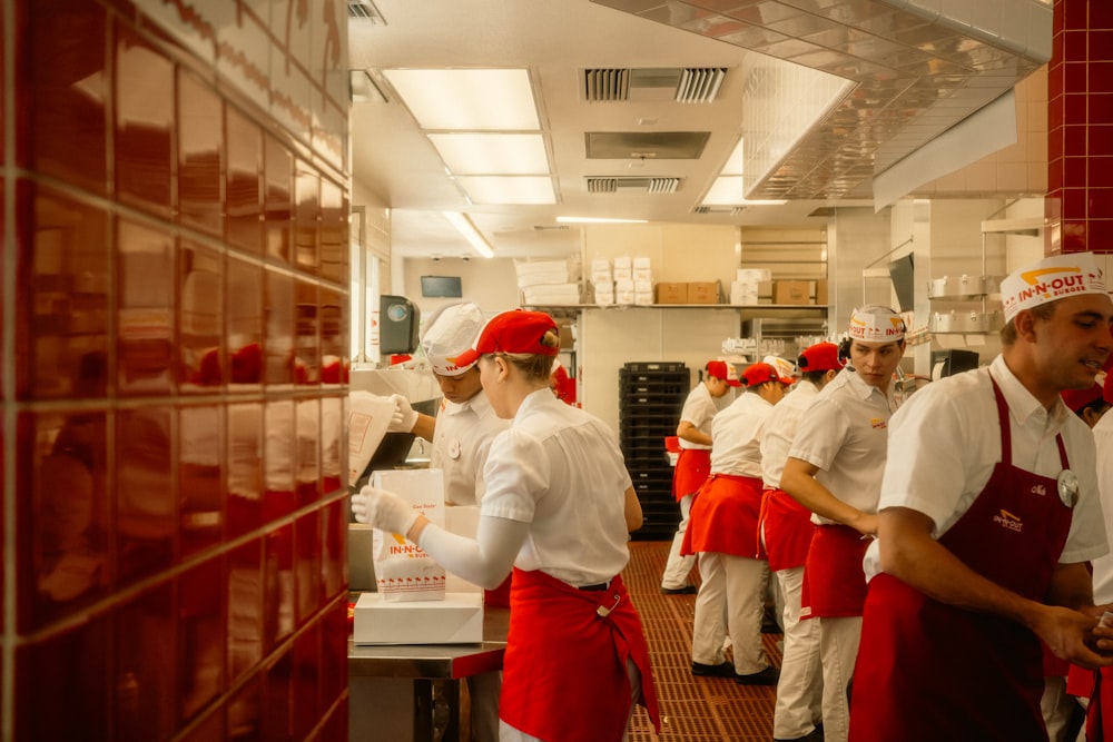 PAR Brink API and Custom Integrations for Restaurants 25 Restaurant staff in red aprons working in a kitchen.