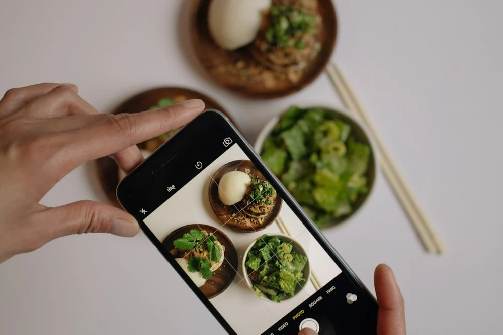 Fooda marketing agency person taking picture of vegetables