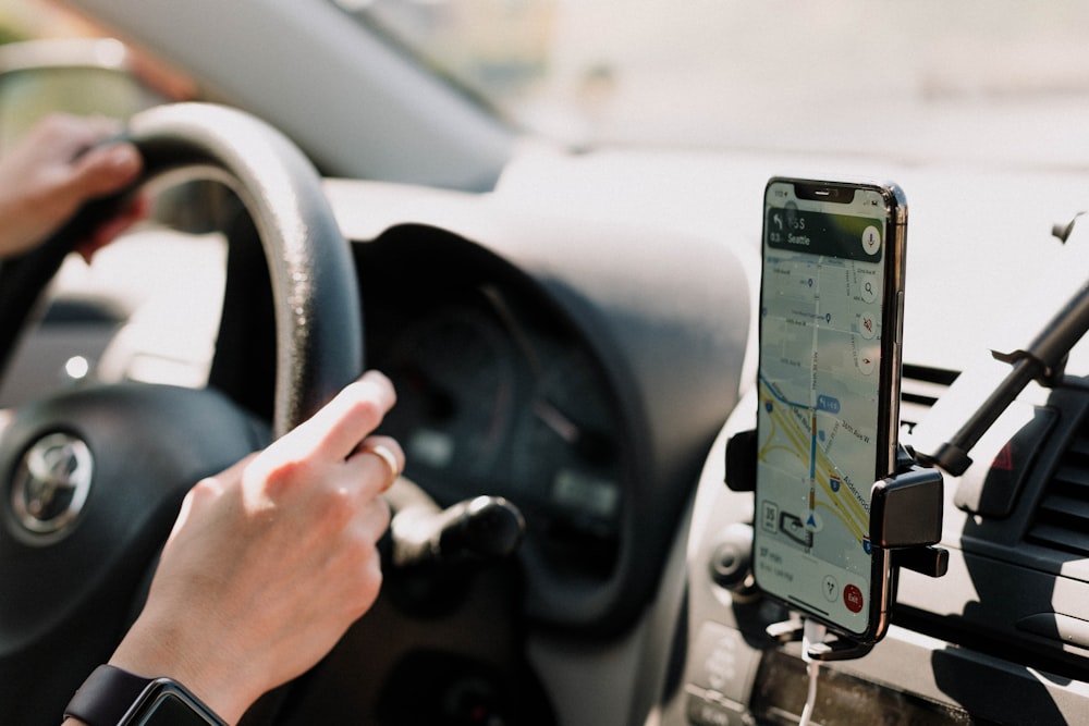 Aloha Website Development for Restaurants 26 a person using a cell phone while driving a car