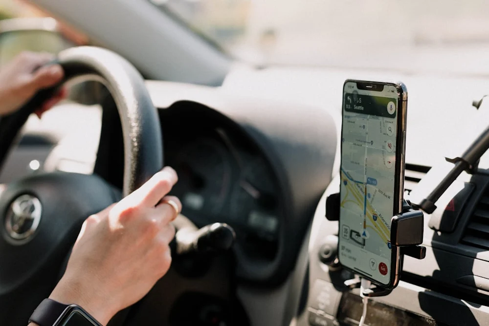 ezCater listing optimization a person using a cell phone while driving a car