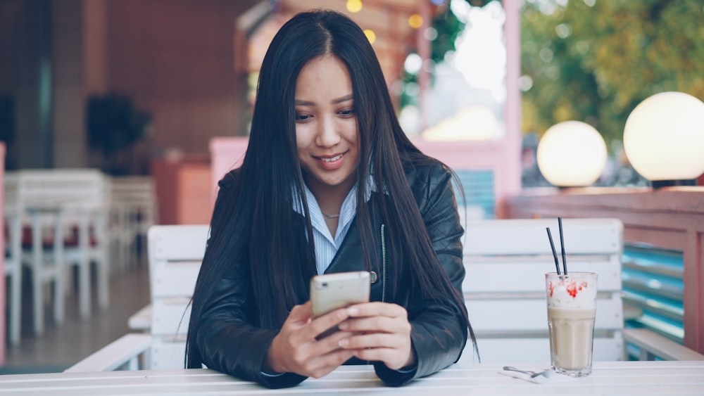 Lightspeed API and Custom Integrations for Restaurants 25 Young woman smiling while looking at her phone