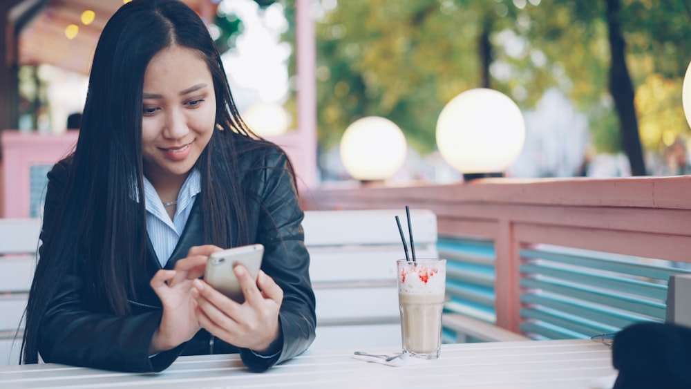 Square Website Development for Restaurants 27 Young woman looking at phone at outdoor cafe