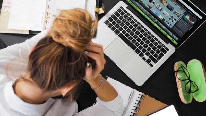 Business owner reviewing common website design mistakes austin companies make