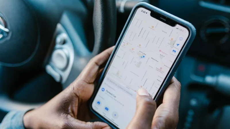 Person checking a business location on a smartphone map app during google business profile setup