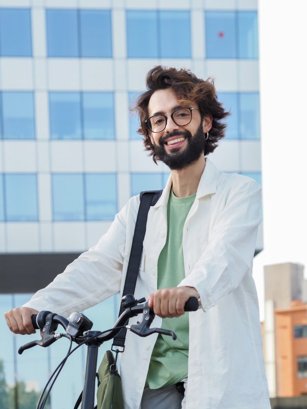 young-digital-entrepreneur-man-with-a-bike-in-a-financial-district-looking-at-camera.jpg